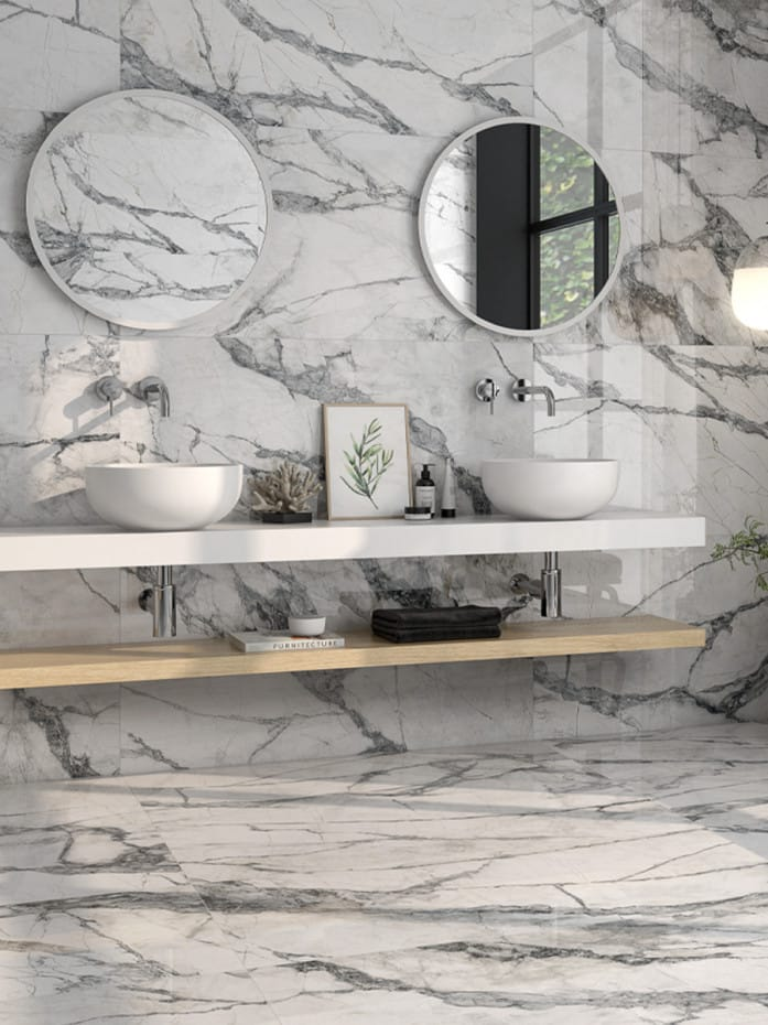 Marble-look tiled bathroom walls and floors with twin basins